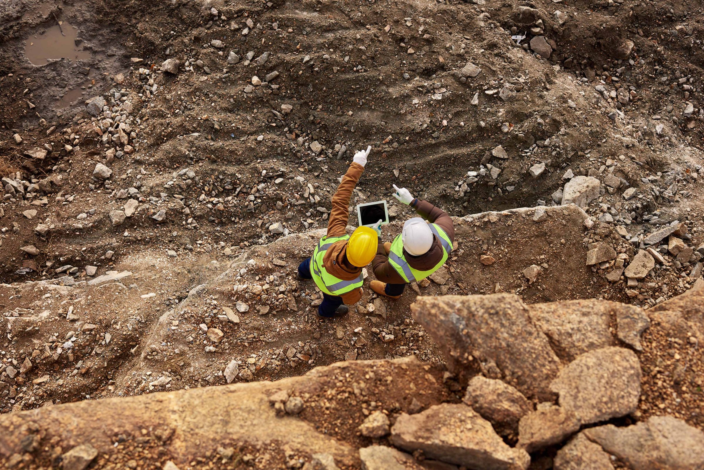 Aerial view of engineers surveying a surface mining site